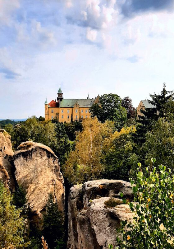 The historic Hrubá Skála Castle perched dramatically atop towering sandstone rock pillars in the scenic Bohemian Paradise region of the Czech Republic.